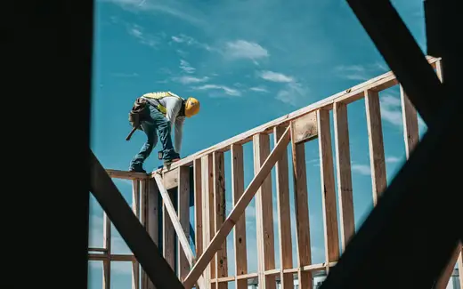 construction worker in hard hat on building frame