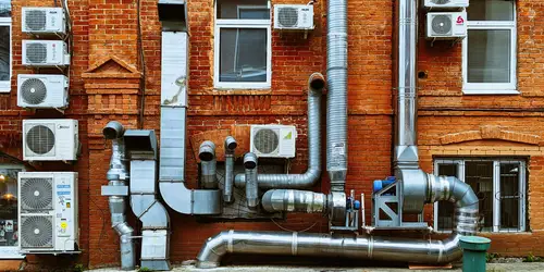 a building with a bunch of pipes on the side of it